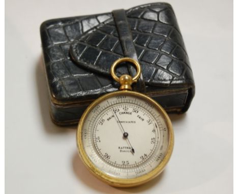 A lacquered brass cased pocket barometer by Rattray of Dundee, having signed silvered dial, the back cover with inset compass