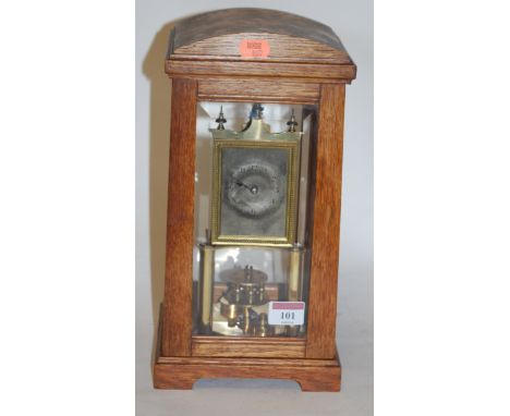 An early 20th century oak cased Torsion mantel clock, having silvered dial with Arabic numerals, the movement signed B.H.A.
