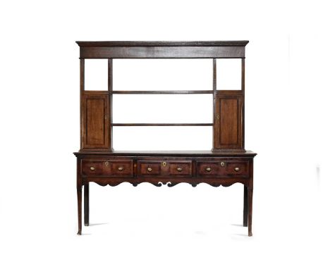 A 17th / 18th century cross-banded oak dresser and later rackThe rack with cavetto cornice above a plain frieze and two shelv