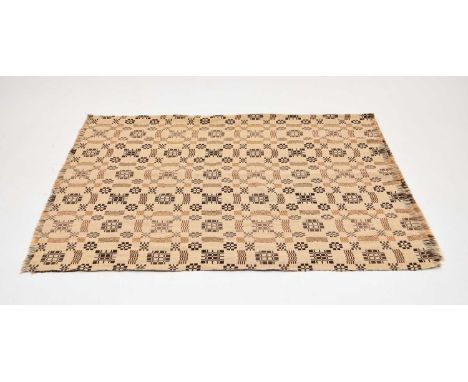 A 20th century Welsh blanket, worked in dark brown, rust and grey threads with cruciform, gate and checquer motifs, labelled 