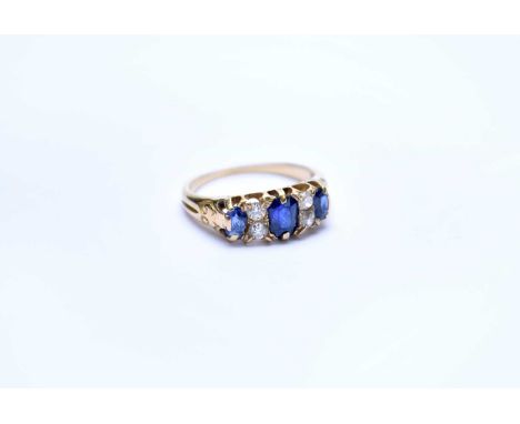 A seven stone sapphire and diamond ring, designed as three oval mixed cut sapphires interspersed with four old cut diamonds, 