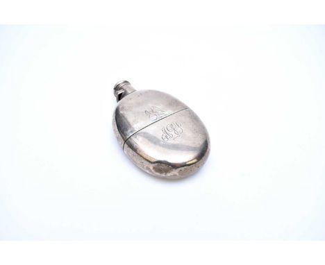 A Victorian silver hip flask, London 1874, of oval form with removable cup and engraved crest and monogram, 13.5cm high, weig