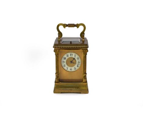 An early 20th century brass carriage clock, with a 2.25" circular dial, the 8-day lever movement with compensated balance whe