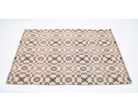 A 20th century Welsh blanket, worked in dark brown, rust and grey threads with cruciform, gate and checquer motifs, labelled 