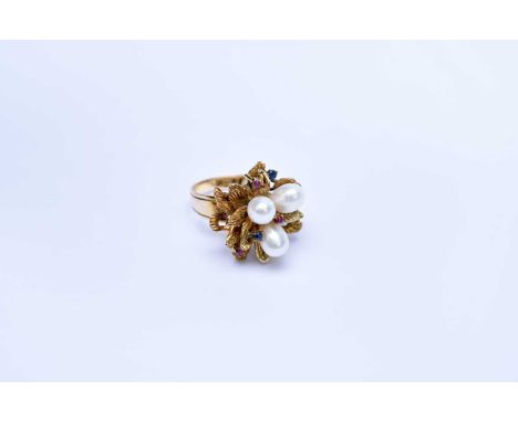 A freshwater pearl, sapphire and diamond cocktail ring, designed as three pearls mounted within stylised leaves and set with 