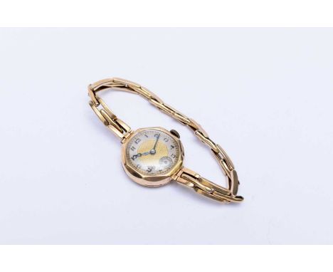 A lady’s 9ct yellow gold cocktail or dress watch, 1933, the round case with faceted bezel on an expanding three-link bracelet