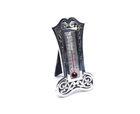 An Edwardian silver mounted thermometer, Bimingham 1906, of cartouche form with pierced scroll and foliate decoration, with e