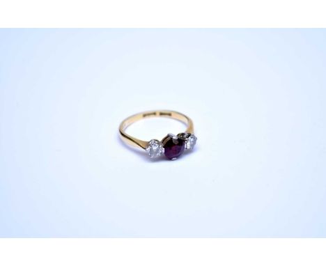 A three stone ruby and diamond ring, the yellow metal shank stamped '18 &amp; pt', ring size J, weight approx 2.1gDiamonds ea