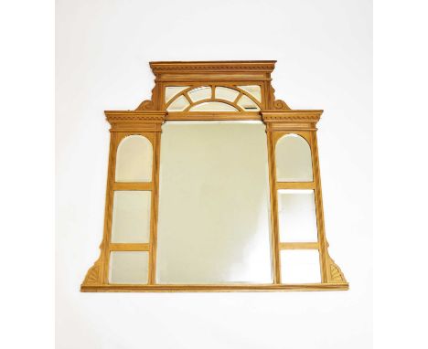 A late Victorian giltwood overmantel mirror, of architectural form and comprising 14 shaped bevelled plates, 130cm wide x 127