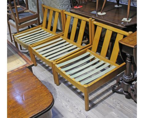 A set of three Ercol light beech easy chairs.