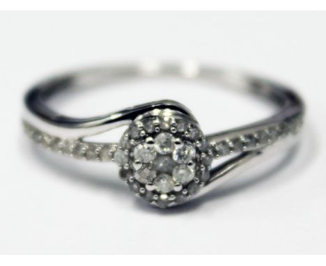 A modern hallmarked 9ct white gold diamond encrusted ring, gross wt. 2.4g, size R.