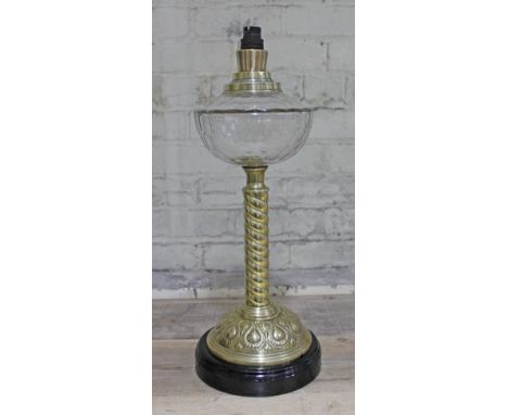 An Arts & Crafts style twist brass lamp base with facetted glass reservoir and pot base, height 55cm.