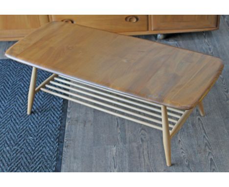 An Ercol light elm and beech coffee table with lower spindle tier, length 105.5cm, depth 46cm & height 36cm.