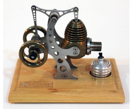 A Bohm Stirling engine on beech base, length 16cm.