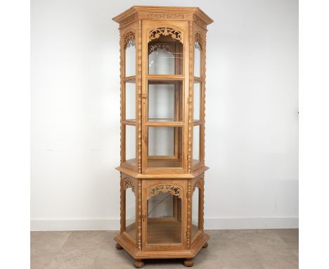 Thai carved teak hexagonal two tier display cabinet with lighting. The top tier with two glass shelves above wooden base, the