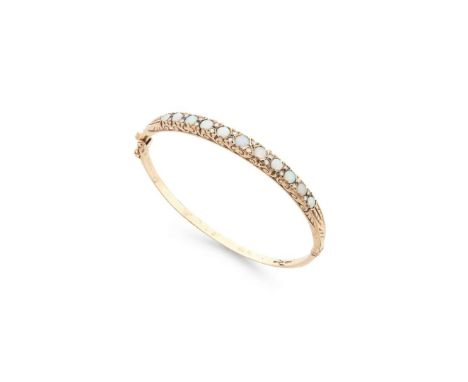  A 9ct gold opal and diamond bangle  Of hinged design, set with eleven round cabochon opals and small round brilliant-cut dia