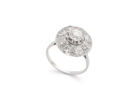  A diamond cluster ring  Claw-set with an old cushion-cut diamond, in a border of eight smaller old round-cut diamonds, plain