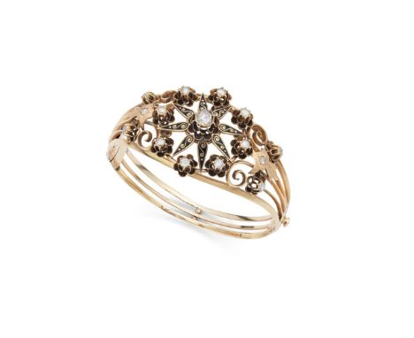  An enamel and diamond bangle  Of hinged design, the front half with pierced detail set with black enamel and rose-cut diamon