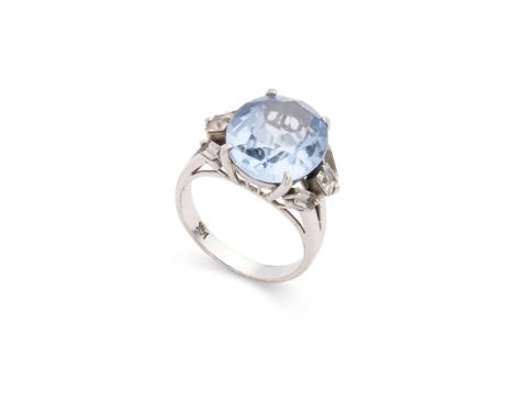 A blue spinel and diamond dress ring Claw-set with a oval-cut blue spinel, each shoulder set with three square and rectangula