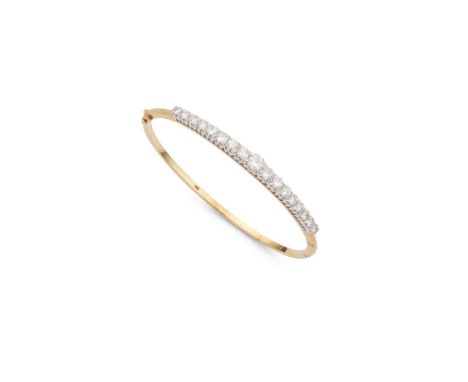  A diamond bangle  Of hinged design, the front half claw-set with seventeen graduated round brilliant-cut diamonds, stamped 7