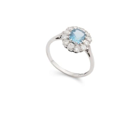  An aquamarine and diamond cluster ring  Claw-set with a rectangular step-cut aquamarine, in a border of old round-cut diamon