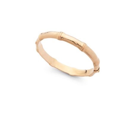  A bamboo-style bangle  Of hinged design, with polished bamboo-style finish, stamped 15 Internal width: 5.6cm   