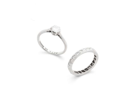 A diamond single-stone ring and eternity ring  The solitaire ring claw-set with a round brilliant-cut diamond, weighing appr