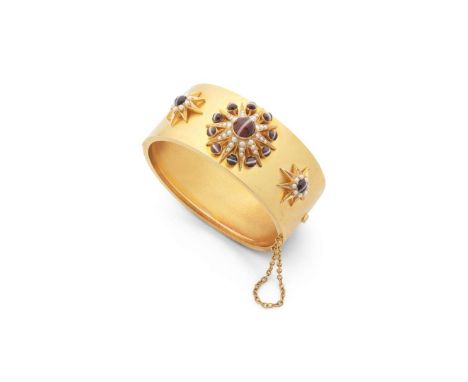  A Victorian agate and seed pearl bangle, circa 1880s  Of hinged design, the front set with three star-shaped clusters collet