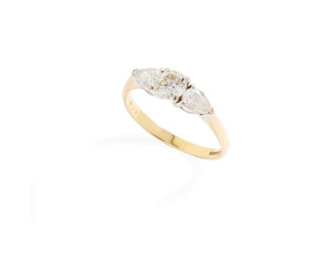  An 18ct gold diamond three-stone ring  Claw-set with a round brilliant and two pear-shaped diamonds, totalling approximately