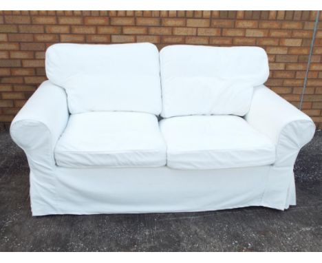 A contemporary white Ikea two-seater sofa, approximate height 90 cm x 180 cm x 82 cm. Estimate £50 - £80 - This lot MUST be p