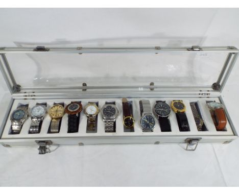 A display case containing twelve watches to include Rotary, Timex, Sekonda, Rojas and similar - This lot MUST be paid for and