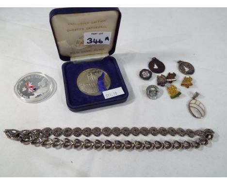 A good mixed lot to include a small quantity of white metal and enamelled pin badges, medals, an Exclusive Edition Chester Ca