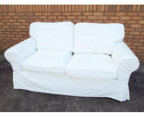 A contemporary white Ikea two-seater sofa, approximate height 90 cm x 180 cm x 82 cm. Estimate £50 - £80 - This lot MUST be p