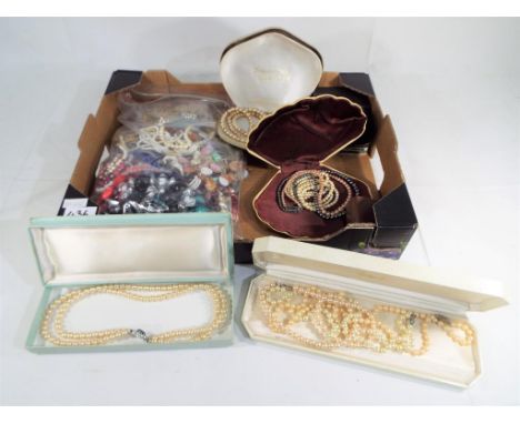 A jewellery box and a bag of assorted costume jewellery to include various boxed sets of pearl necklaces and hat pins - This 