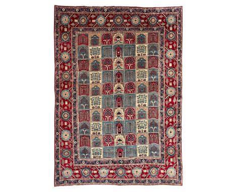 Persian Bakhtiari crimson ground carpet, the field divided into seventy panels decorated tree of life motifs, mihrabs and sty