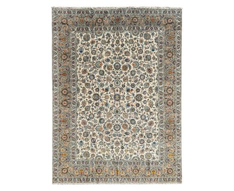 Persian Kashan ivory ground carpet, overall floral design, the busy field decorated with multiple palmettes united by trailin