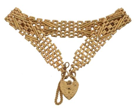 A 9ct gold gate link bracelet. The gate link chain with heart shape padlock clasp, hallmarks for London, length 19.3cm, gross