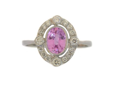 A sapphire and diamond dress ring. The oval shape pink sapphire weighing approx. 0.85ct within a brilliant cut diamond surrou