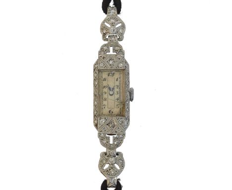 An early 20th century diamond cocktail watch.  The rectangular shape dial with arabic markers and outer minutes tracked, unsi