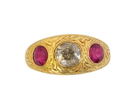 A late Victorian gem-set three stone ring. Of Celtic design, the old cut diamond and later circular shape synthetic rubies in