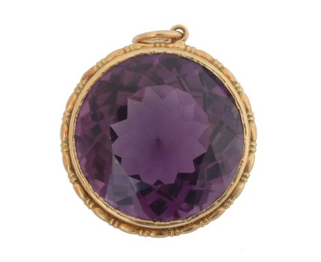 A 9ct gold amethyst pendant. The circular shape amethyst weighing approx. 37cts within a grooved pendant mount, hallmarks for