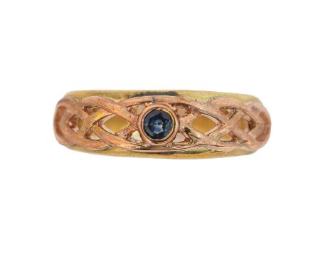 A 9ct gold Clogau sapphire band ring. The circular shape sapphire inset to the bi-colour openwork band, signed Clogau, hallma