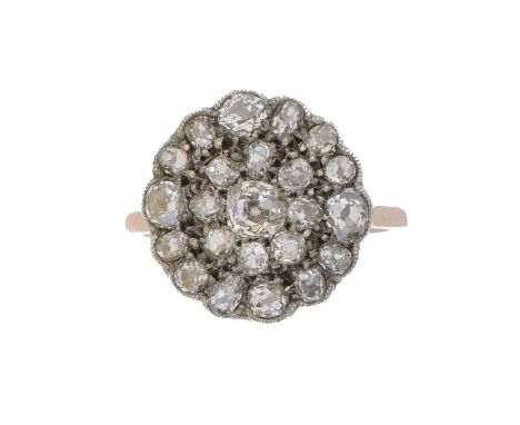 A diamond cluster ring. The old cut diamond within a similarly cut diamond double surround, estimated total diamond weight 1.