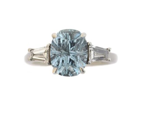 A platinum aquamarine and diamond three stone ring. The oval fancy cut aquamarine weighing approx. 2.10cts with tapered bague