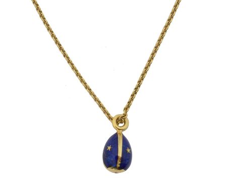 An 18ct gold Fabergé enamel egg pendant on chain. The blue guilloche enamel egg with star detailing, suspended from a trace l