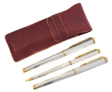 Three Waterman pens in a Cartier pouch. Including a pencil, biro and fountain pen with 18k nib, within a Cartier leather pouc