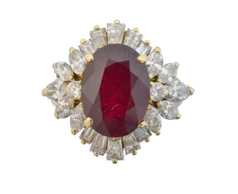 A ruby and diamond cluster ring.  The oval shape ruby weighing approx. 2.65cts within a tapered baguette, brilliant and pear 