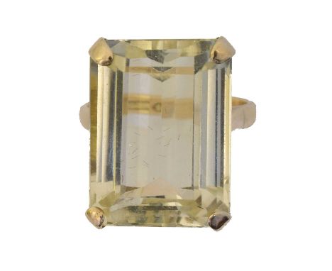 A citrine single stone ring. The rectangular shape citrine weighing approx. 19.5cts within a four claw setting, stamped 14K, 
