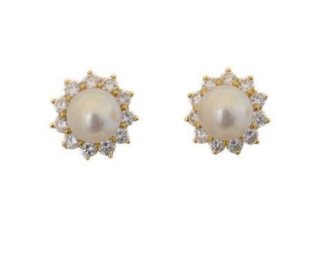A pair of cultured pearl and diamond earrings by Mikimoto. Each designed as a round cultured pearl measuring 7.7 to 7.75mm wi