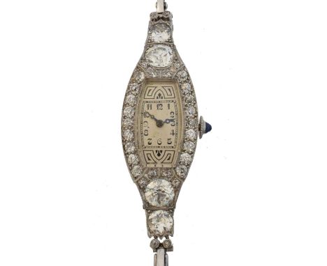 An early 20th century diamond cocktail watch. The tonneau dial with arabic markers and outer minutes track, unsigned manual w